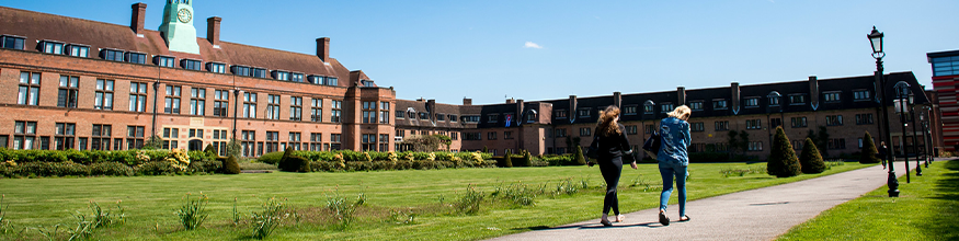 students walking through sunny campus hope park